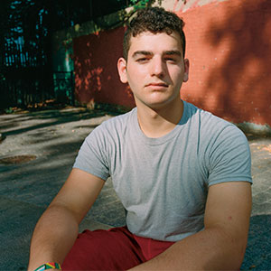 Caleb Mints sits outside.