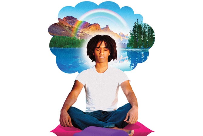 A young man meditates while thinking about a forest, lake, rainbow, and mountains.