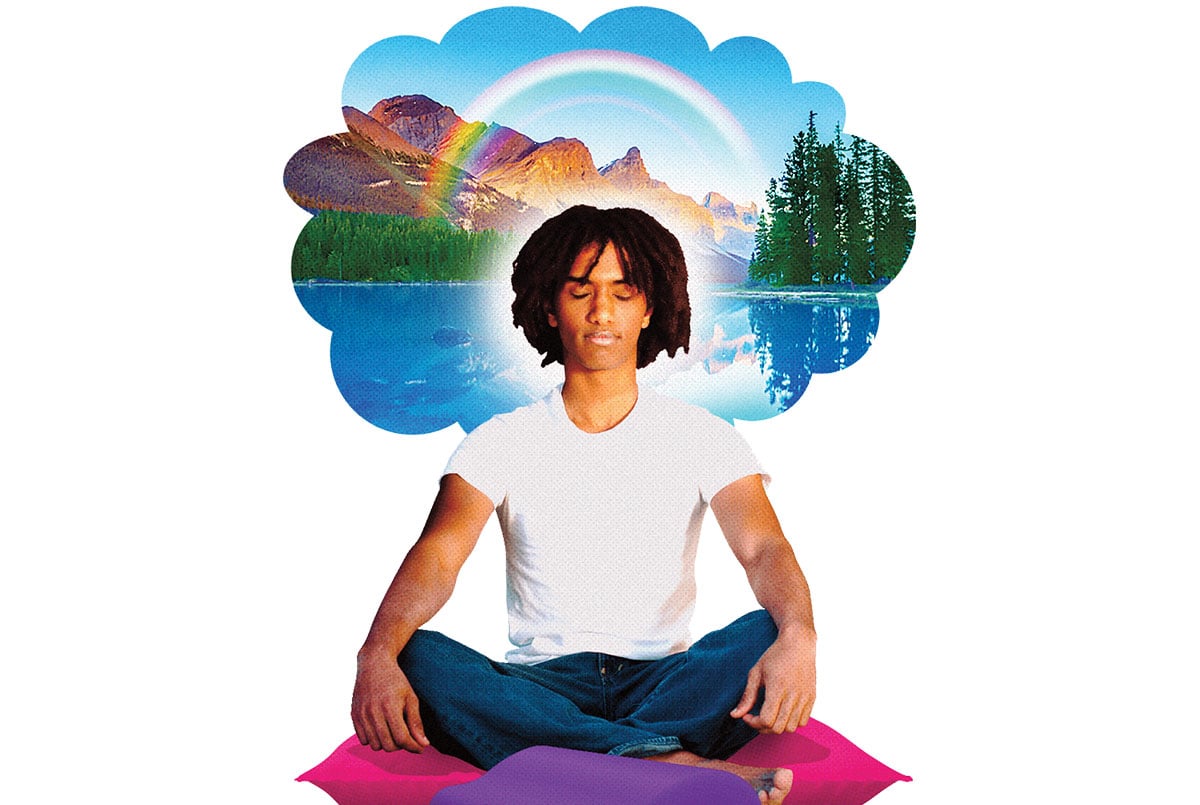 A young man meditates while thinking about a forest, lake, rainbow, and mountains.