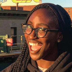 a girl wearing glasses with a big smile