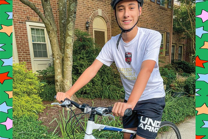 enlargeable picture of a boy wearing a helmet while riding a bike