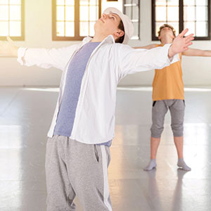 two teens holding their arms open