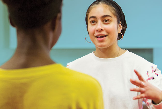 a girl talking and waving her hands