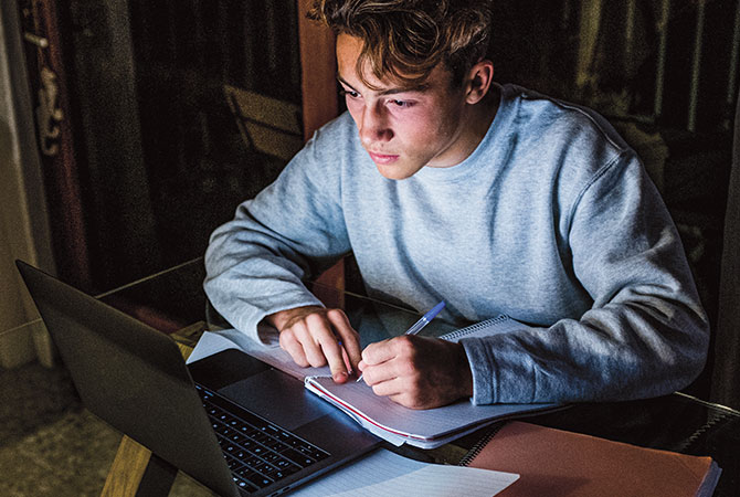 Teen on a computer doing schoolwork