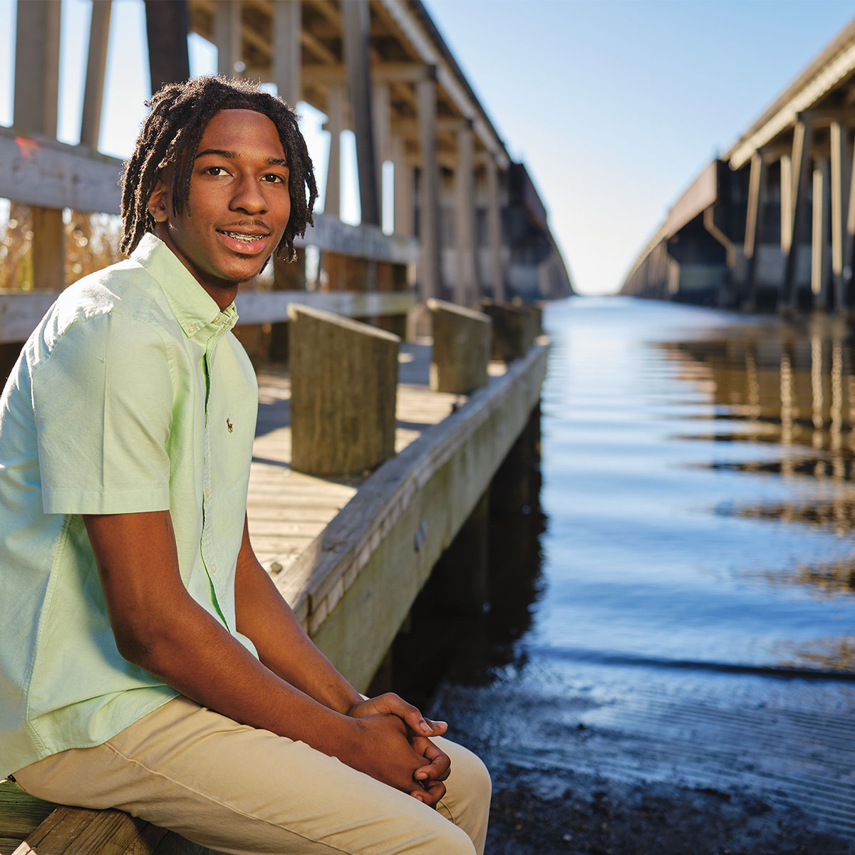 Photo of teen hanging by a dock by the water