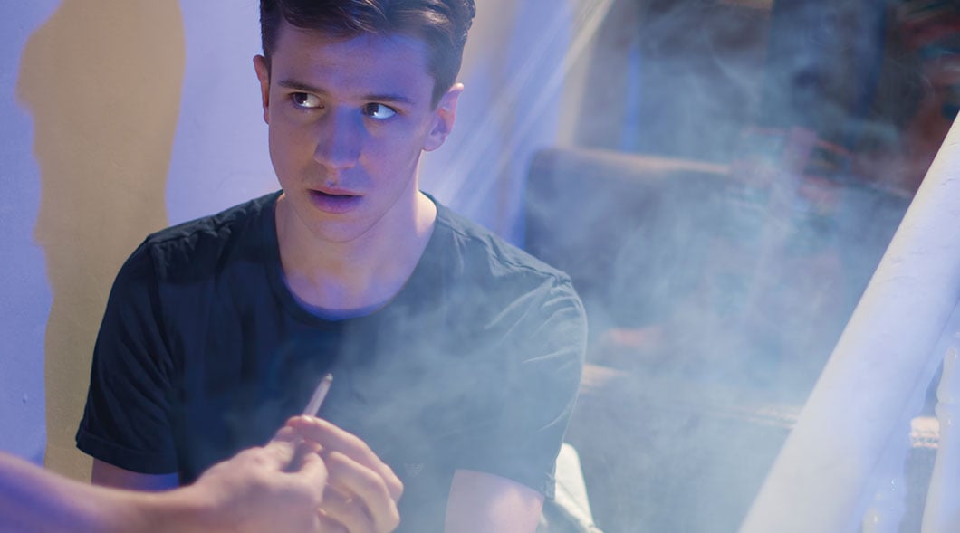 Photo of a teen being offered to smoke a joint