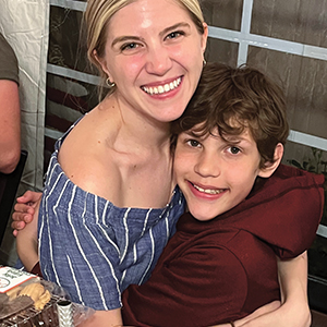 Two people hugging one another and smiling