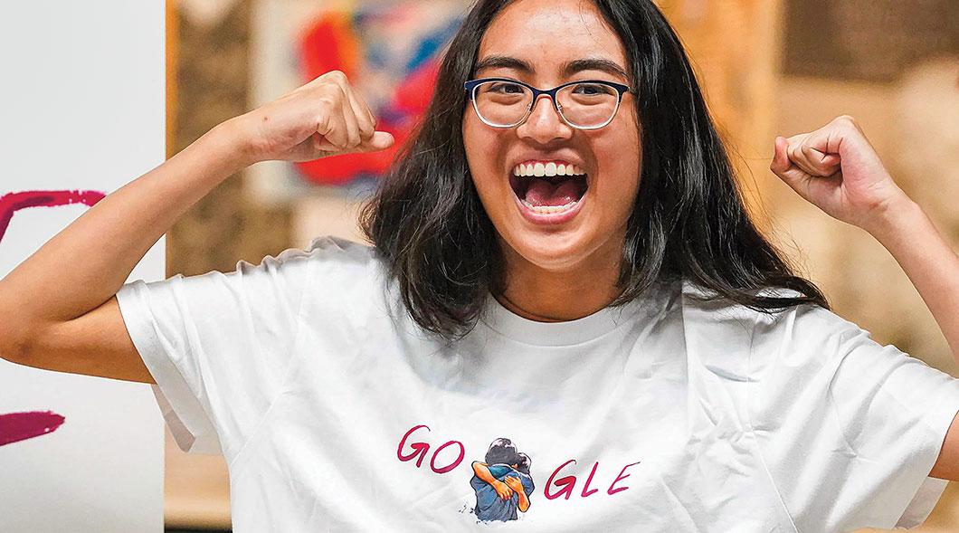 Photo of a cheering teen wearing a Google tshirt