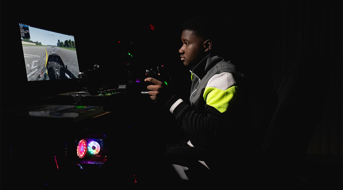 Image of a teen playing a car racing video game