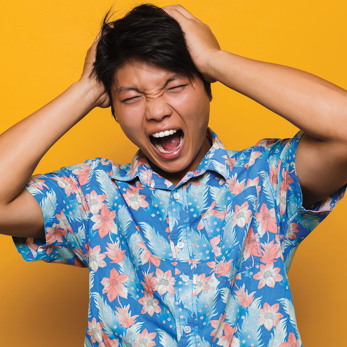 Image of a person grabbing their head and appearing to be yelling