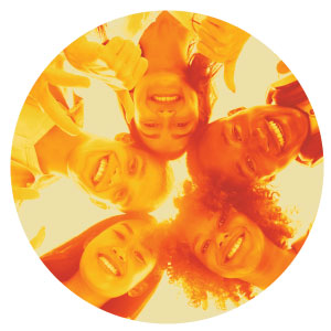 Image of five teens smiling with their heads touching in a circle