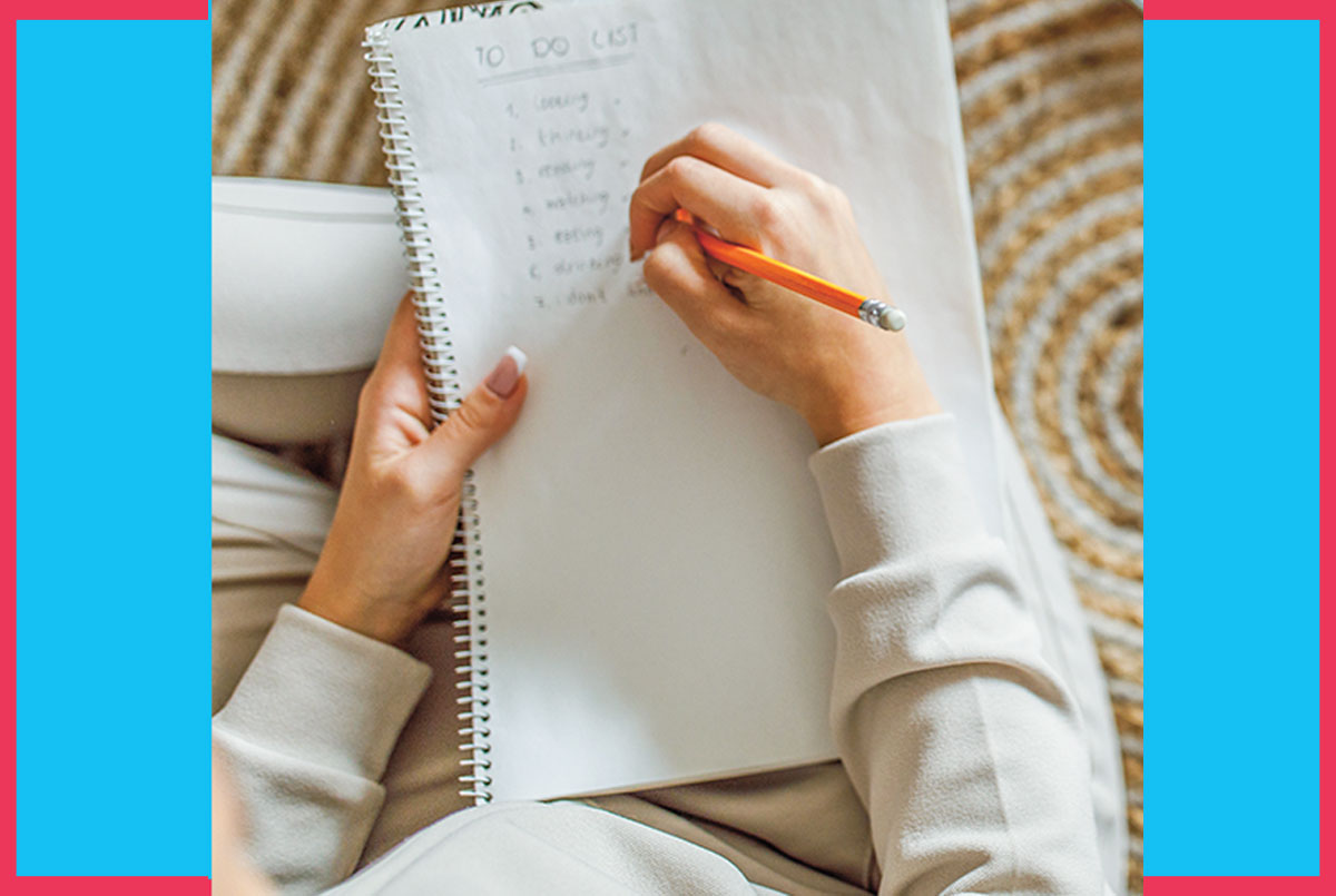Image of a person writing in a notebook