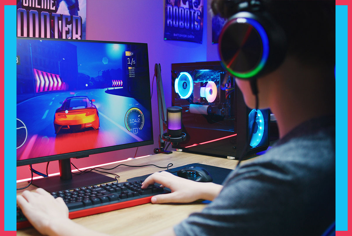 Image of a person playing a racecar videogame at their desk