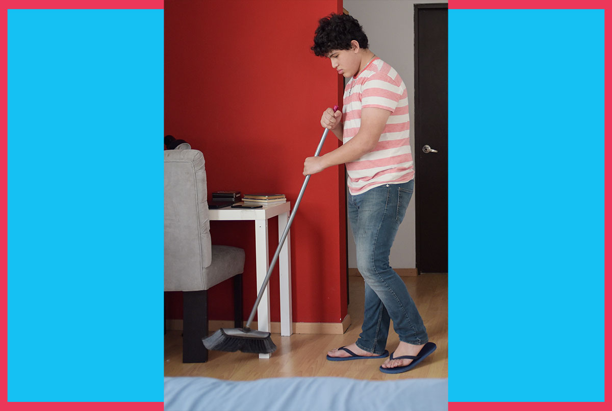 Image of a person sweeping a room with a broom