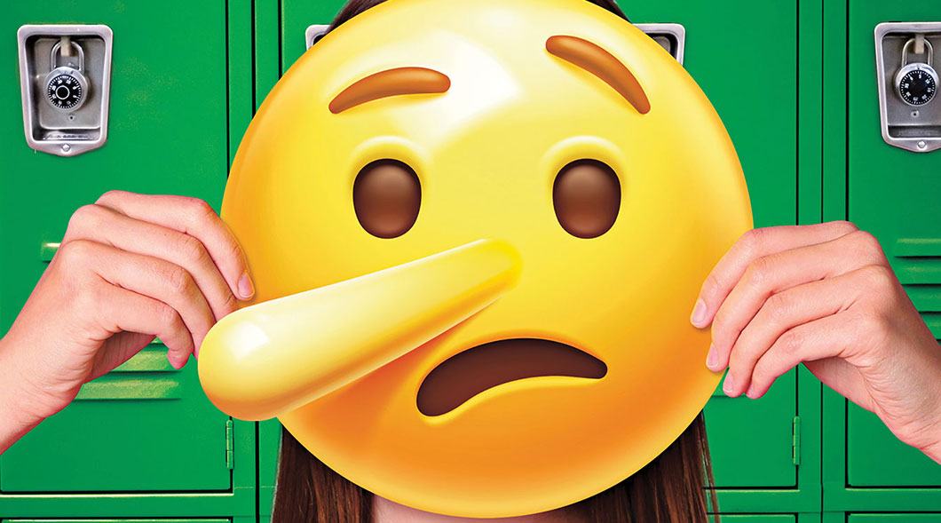 Image of a person holding a lying emoji face