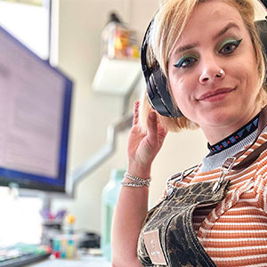 Image of videogame artist at work and wearing a headset