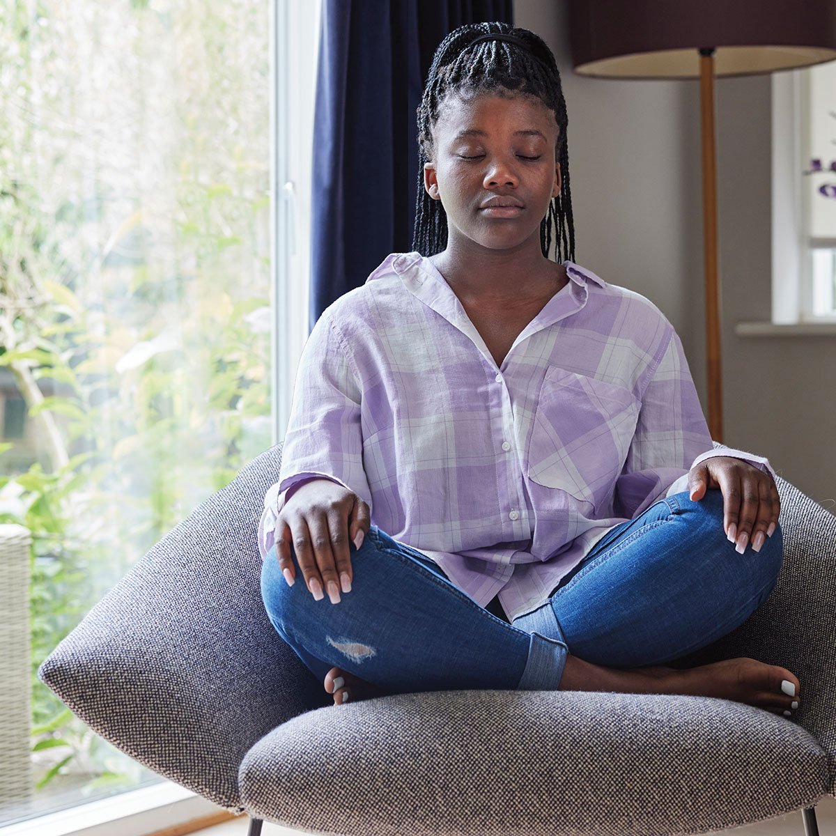 Image of a teen meditating in a chair