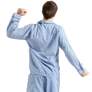 a boy in pajamas stretching